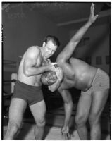 Wrestler and football player Bronko Nagurski with challenger Vincent López in a headlock during a wrestling match at Wrigley Field, Los Angeles, 1937