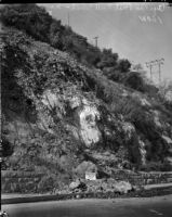 Sign warns pedestrians and drivers of landslide danger near the Figueroa St. tunnel, Los Angeles, November 1937