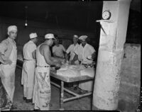 Men knead and roll dough in a large room, Los Angeles, November 1937