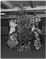 Matron Vada Sullivan Russell and others decorate a Christmas tree at the Los Angeles County Jail, 1930s