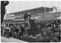 Spectators watch a race on opening day of Santa Anita's fourth horse racing season, Arcadia, December 25, 1937