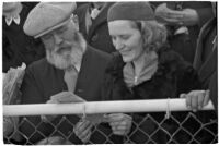Spectators check their betting sheet on opening day of Santa Anita's fourth horse racing season, Arcadia, December 25, 1937
