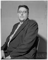 Ned Cronin, Los Angeles Daily News sports editor, posing in a chair, Los Angeles, January 1940