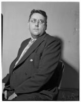 Ned Cronin, Los Angeles Daily News sports editor, posing in a chair, Los Angeles, January 1940