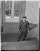 Judge Stanley Moffatt posing at the bottom of a staircase, Huntington Park
