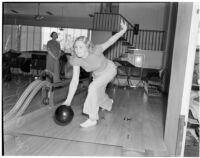 Mrs. Argyle H. Gudie bowling during the Woman's Field Day Challenge as event chairman Mrs. William E. Beatty looks on, May 1939