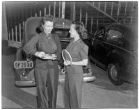 Mrs. Kenneth Holmes and Mrs. Gwynn Fielding holding tennis rackets, Los Angeles, circa 1940