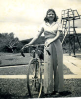 Girl standing with bike