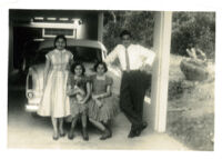 The Guardia Family posing by car