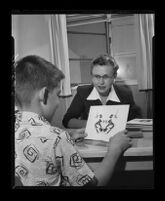 Boy takes ink blot test administered by Dr. W. Lucas, Los Angeles, 1955