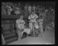 Steve Bilko and Bob Anderson with baseball trophies, Los Angeles, 1956