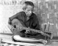 Blind man playing a plucked lute