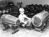 Marlowe Hood surrounded by different sized drums