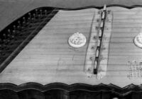 Close-up of characters assigned to each string on board zither