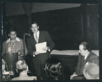 Attorney Jerry Giesler listening to a speech, Los Angeles, 1950s