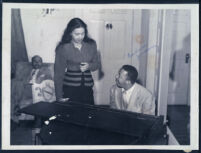 Musician Calvin Jackson and an unidentified woman in Walter L. Gordon, Jr.'s home office, Los Angeles, 1940s