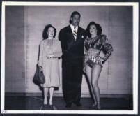 Heavyweight boxing champion Joe Louis with two women, Los Angeles, 1940s