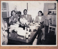 Leonard McClain and his sisters at a dinner party, Los Angeles, 1940s