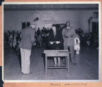 Hazel Washington receiving a certificate from a man in uniform, Los Angeles, 1940s