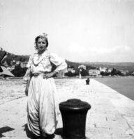 Woman dancer or singer standing by seaside in Gusije