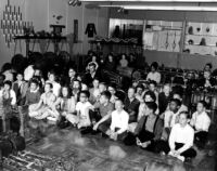 Large group of schoolchildren, singing, in the UCLA gamelan room