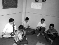 Group of five men playing instruments