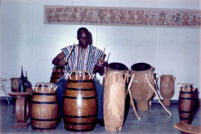 Robert Ayitee playing drums and instructing students