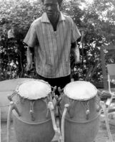 Man playing a set of two Atumpan drums