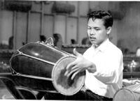 Individual playing a drum