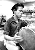Hardja Susilo playing a drum