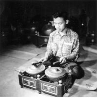 Individual playing two kettle drums