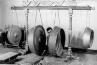 Individual playing gongs.