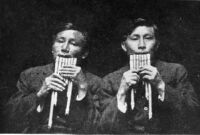 Photo of two Cuna men playing panpipes