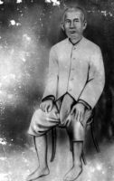 Photograph of a painting of a seated man