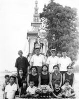 Various funeral attendees posing on top of the float in front of Nai Tun’s stupa