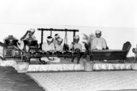 Six musicians performing in a gamelan ensemble