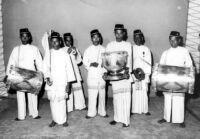 Seven men holding various instruments