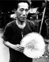Holding the inside face of a drum head which has a spiral inscription written toward the center
