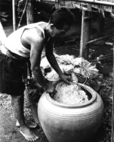 Soaking the drumhead and hide-rope in a large pottery vessel