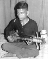 Northern Thai musician plays the sunng (plucked lute), Chiang Mai