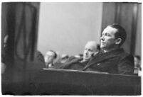 Widower Robert S. James sitting in a courtroom during an inquest involving his wife's death, Los Angeles, 1935