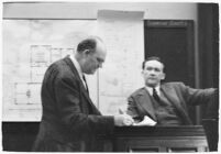 Murder suspect Robert S. James listening to an unidentified lawyer as he sits on the witness stand, Los Angeles, 1936