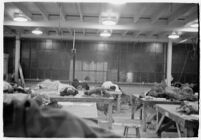 Group of men sleeping at the Douglas Aircraft Corporation plant where workers participated in a sit-down strike, Santa Monica, 1937