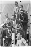 Sports officials keeping time at a track meet between UCLA and USC, Los Angeles, 1937