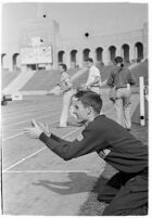 USC track athlete clapping on the sidelines at a meet, Los Angeles, 1937