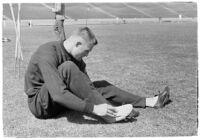 USC track athlete taping his foot on the field, Los Angeles, 1937