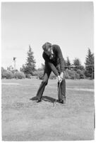 LA Daily News city editor Charles Judson demonstrates improper golf swings for a tutorial series with golfer Fay Coleman.  Circa 1940.
