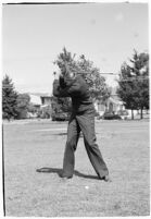LA Daily News city editor Charles Judson demonstrates improper golf swings for a tutorial series with golfer Fay Coleman.  Circa 1940.