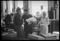 Porters help a passenger with her luggage outside of the S.S. Mariposa, Los Angeles
