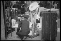 Porter helping a passenger with her luggage outside of the S.S. Mariposa, Los Angeles